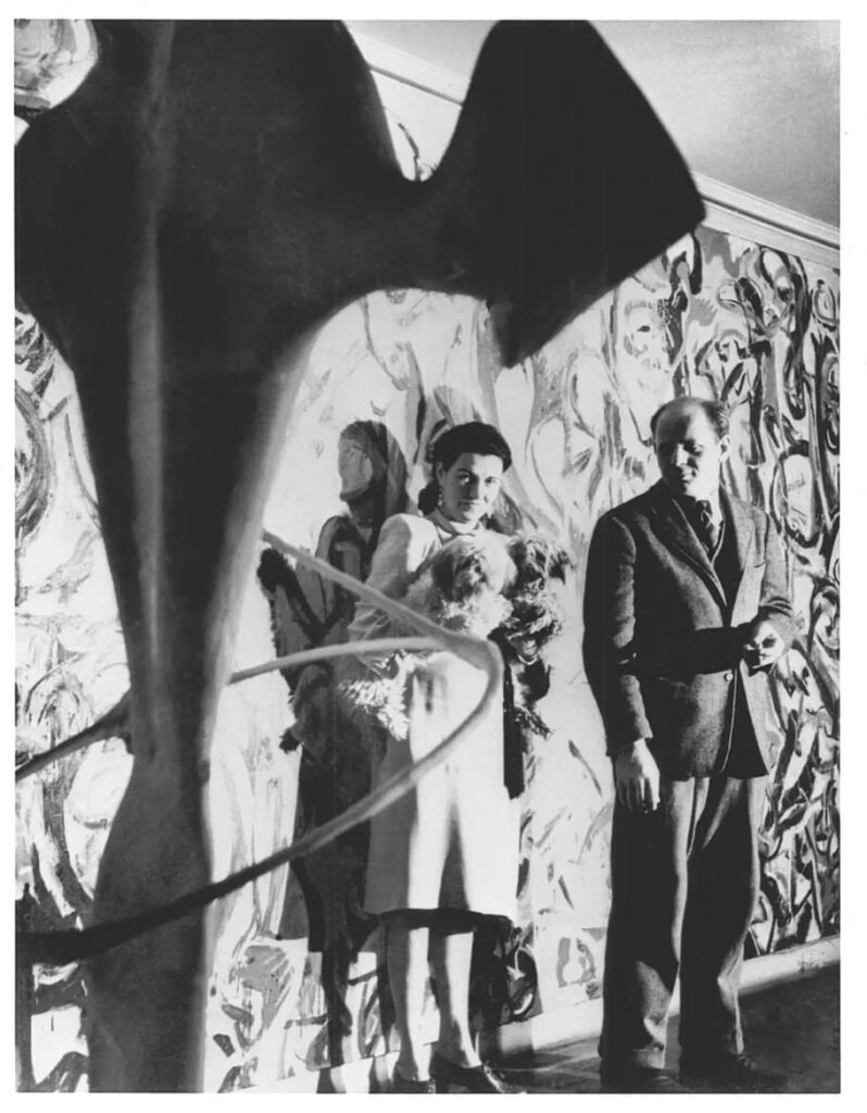 Peggy Guggenheim and Jackson Pollock in front of Pollock’s Mural, 1943.